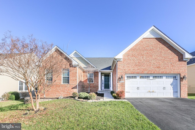 view of front of house featuring a garage and a front lawn