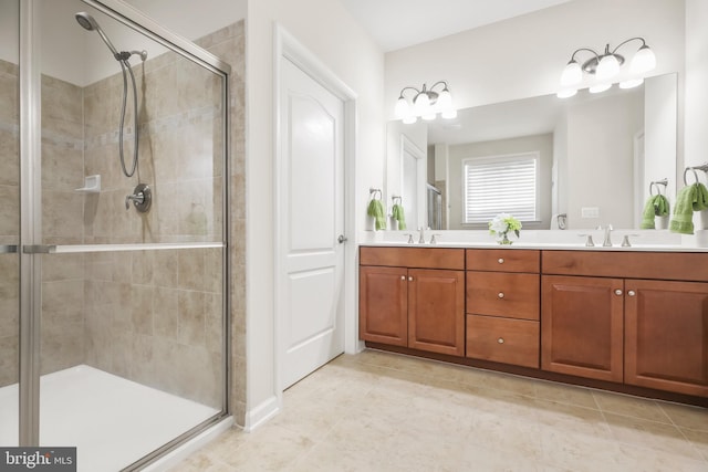 bathroom featuring a shower with door, vanity, and tile patterned flooring