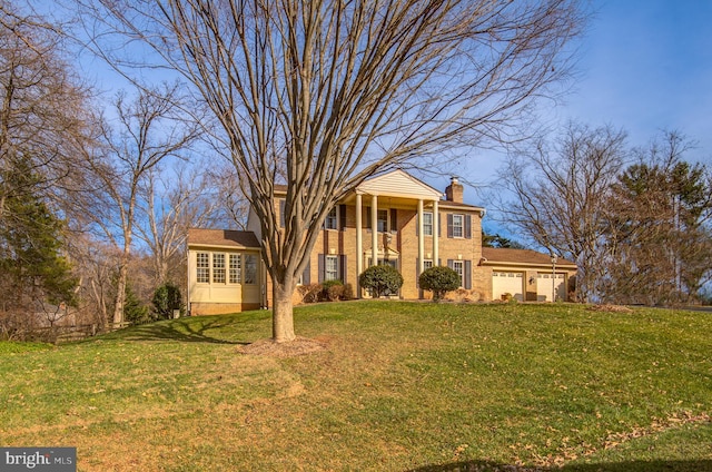 greek revival house featuring a front yard