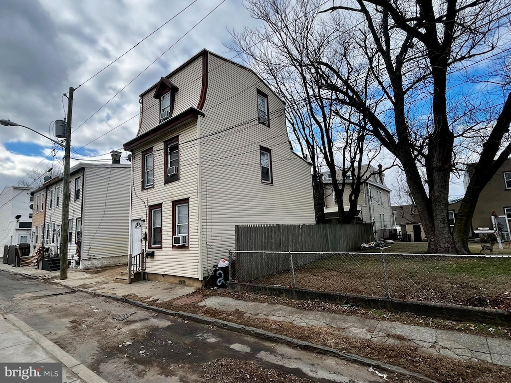 view of side of home featuring cooling unit