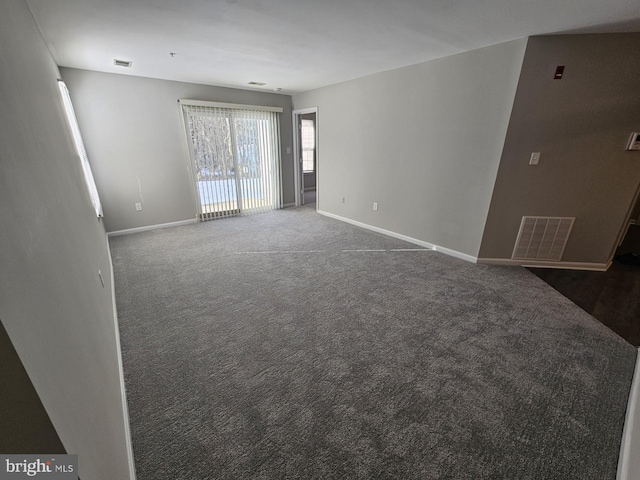 unfurnished room with dark carpet