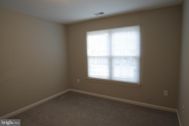 empty room with dark carpet