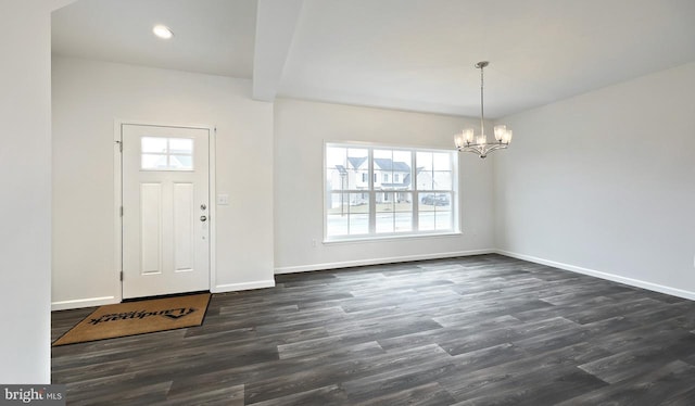 entryway with a chandelier and dark wood-type flooring