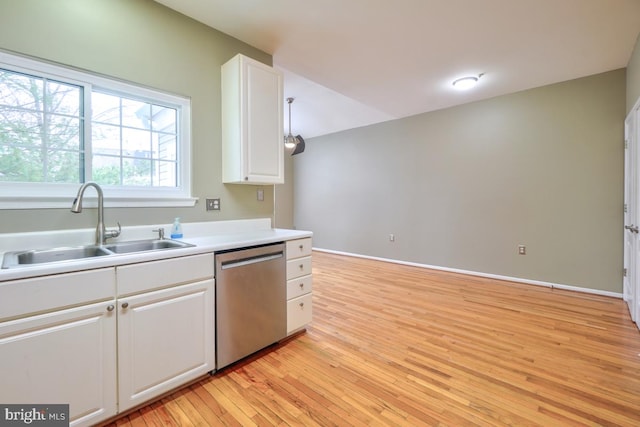 kitchen with white cabinetry, sink, stainless steel dishwasher, and light hardwood / wood-style flooring