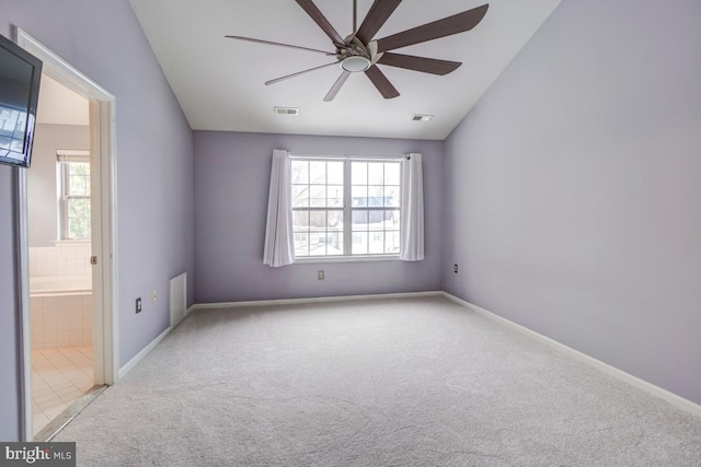 carpeted spare room featuring ceiling fan