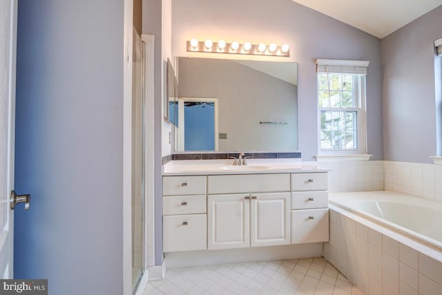 bathroom featuring separate shower and tub, tile patterned floors, vanity, and vaulted ceiling