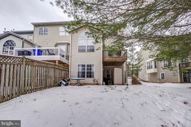 view of snow covered rear of property