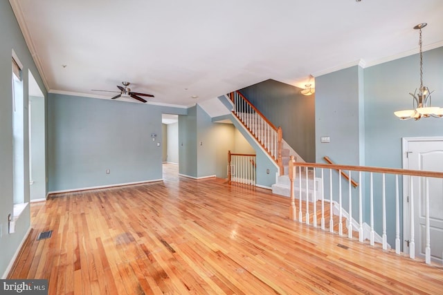 spare room with crown molding, light hardwood / wood-style flooring, and ceiling fan with notable chandelier