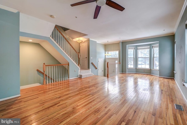 unfurnished living room with light hardwood / wood-style floors, ceiling fan with notable chandelier, and ornamental molding