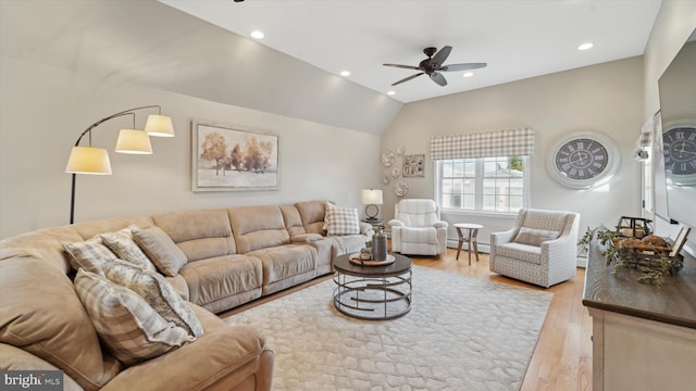 living room featuring a baseboard radiator, ceiling fan, lofted ceiling, and light hardwood / wood-style floors