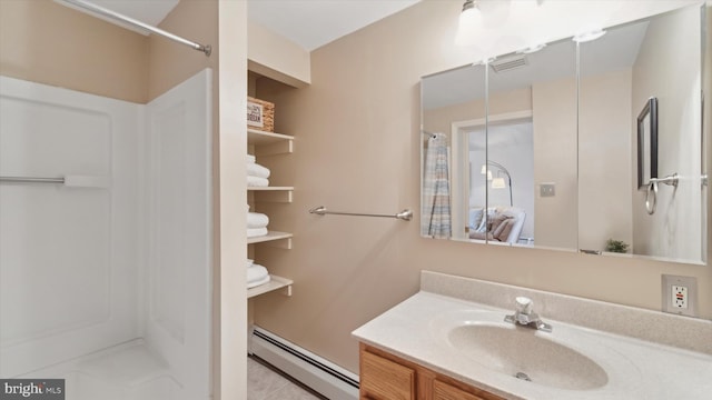 bathroom featuring baseboard heating, a shower, tile patterned floors, and vanity