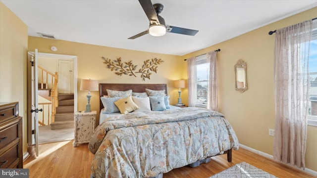 bedroom with light hardwood / wood-style floors and ceiling fan