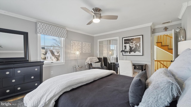 bedroom featuring a closet, ceiling fan, and ornamental molding