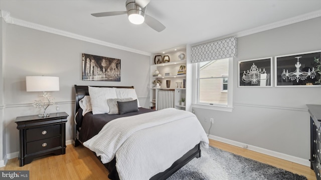 bedroom featuring ceiling fan, light hardwood / wood-style floors, and ornamental molding