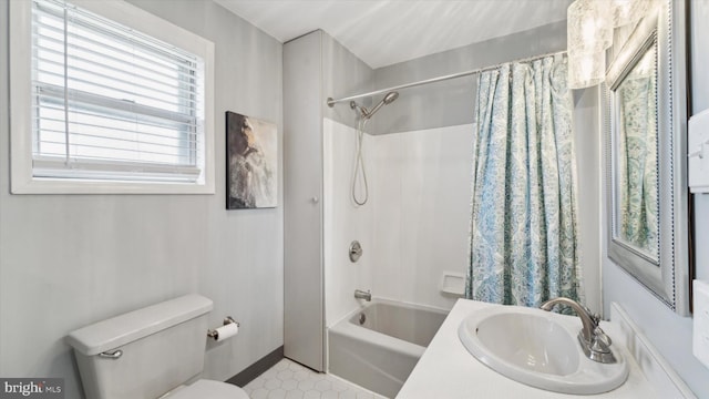 full bathroom featuring tile patterned flooring, shower / bath combo, toilet, and sink