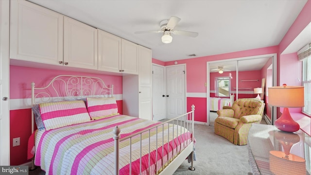 bedroom featuring ceiling fan, a closet, and light colored carpet