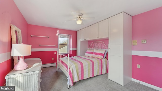 bedroom with ceiling fan, light carpet, and a baseboard heating unit