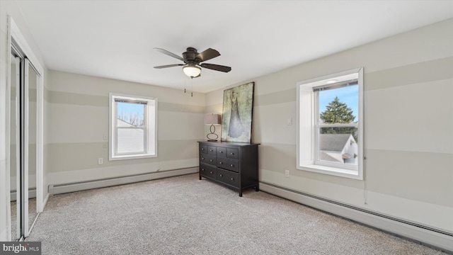 unfurnished bedroom featuring a baseboard radiator, ceiling fan, and light colored carpet