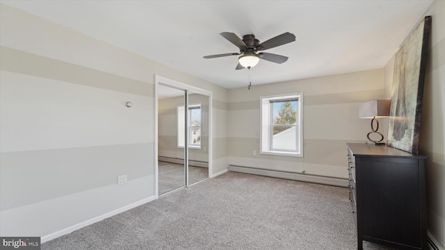 unfurnished bedroom featuring light carpet, a closet, ceiling fan, and a baseboard radiator