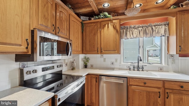 kitchen featuring backsplash, sink, wood ceiling, and appliances with stainless steel finishes