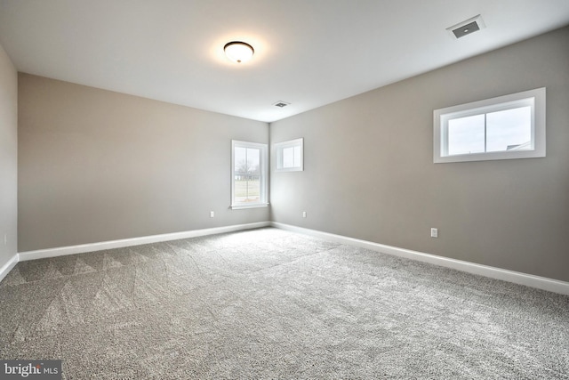 carpeted spare room featuring plenty of natural light