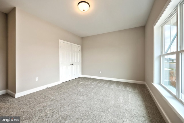 unfurnished bedroom with carpet floors and a closet