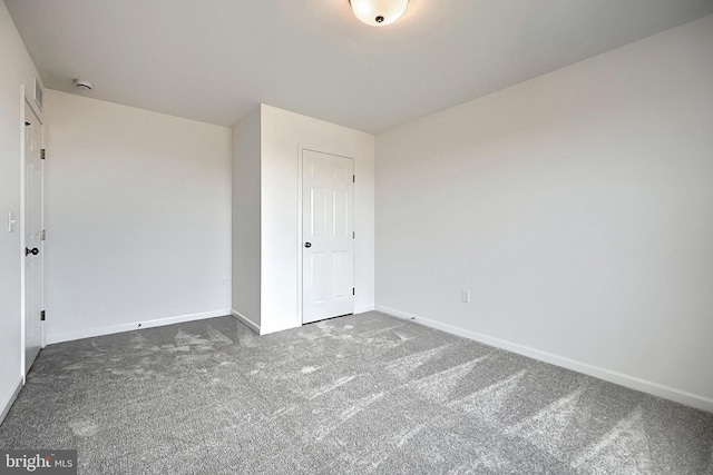 unfurnished bedroom featuring carpet floors and a closet