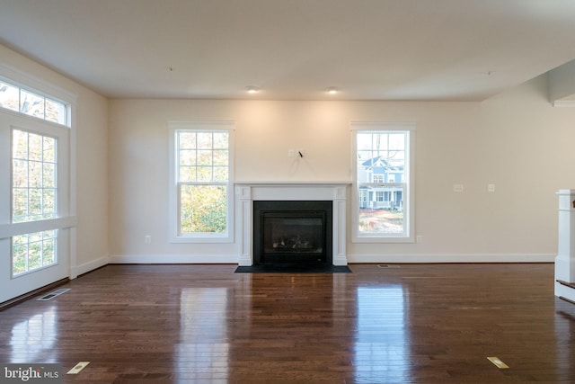 unfurnished living room featuring dark wood-type flooring