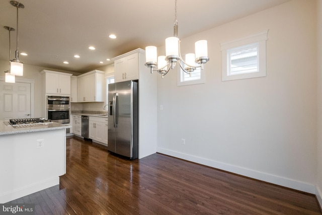 kitchen featuring decorative light fixtures, dark hardwood / wood-style floors, a notable chandelier, stainless steel appliances, and white cabinets