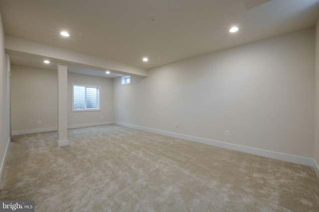 basement featuring light carpet