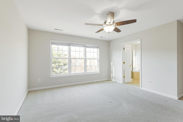 carpeted spare room featuring ceiling fan