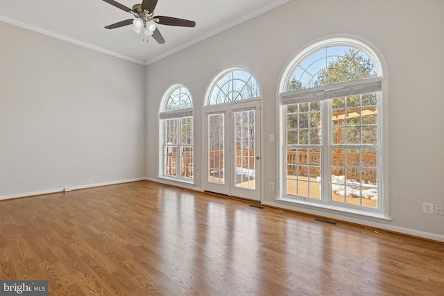 spare room with ceiling fan, crown molding, and wood-type flooring