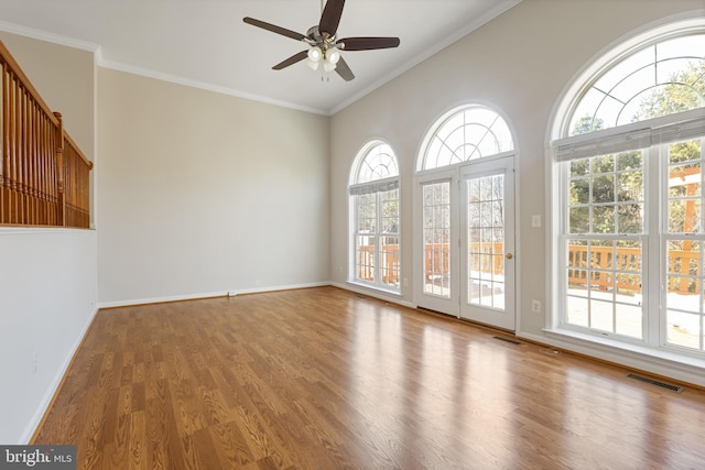 unfurnished room with vaulted ceiling, ceiling fan, ornamental molding, and hardwood / wood-style flooring