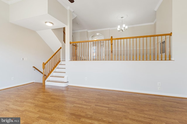 interior space with a chandelier, crown molding, and light hardwood / wood-style floors