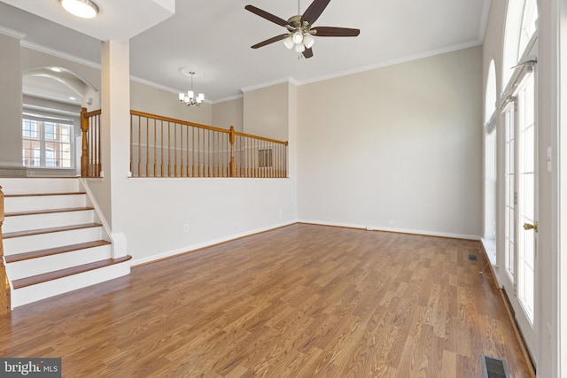 spare room featuring hardwood / wood-style flooring, ornamental molding, and ceiling fan with notable chandelier