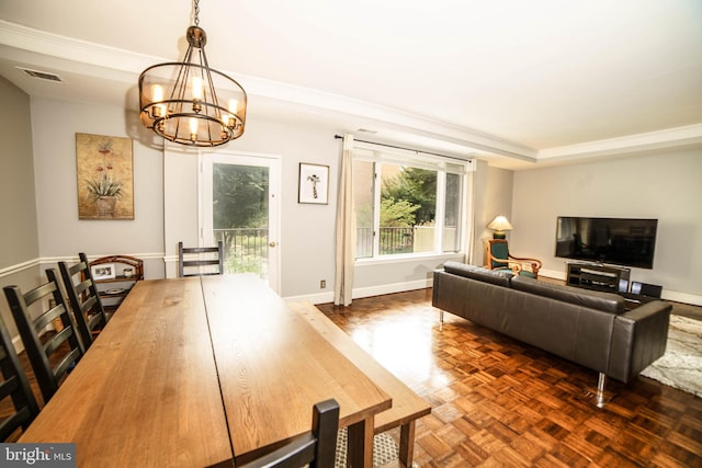 living room featuring dark parquet flooring and an inviting chandelier