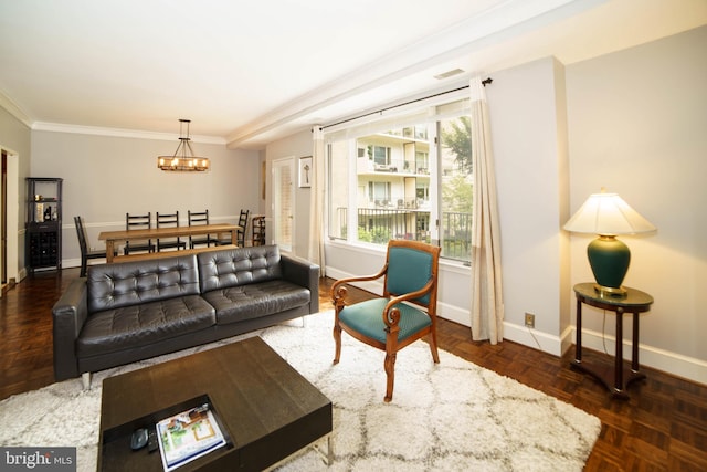 living room featuring dark parquet floors, crown molding, and an inviting chandelier