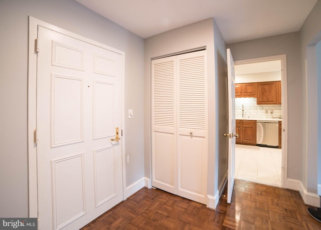 hall with dark parquet flooring