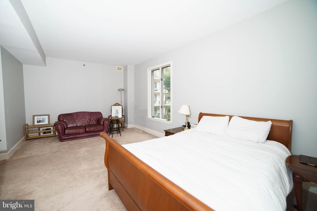 bedroom with light colored carpet