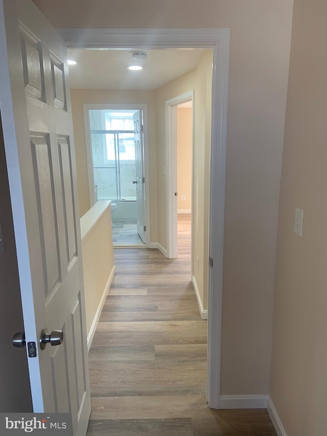 hall with light hardwood / wood-style floors