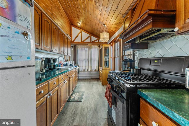 kitchen featuring decorative backsplash, black gas stove, wood ceiling, and sink