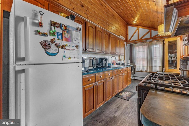 kitchen with gas range, sink, dark hardwood / wood-style floors, white fridge, and wood ceiling