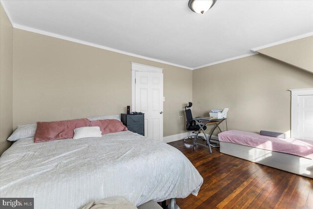 bedroom featuring dark hardwood / wood-style flooring and crown molding