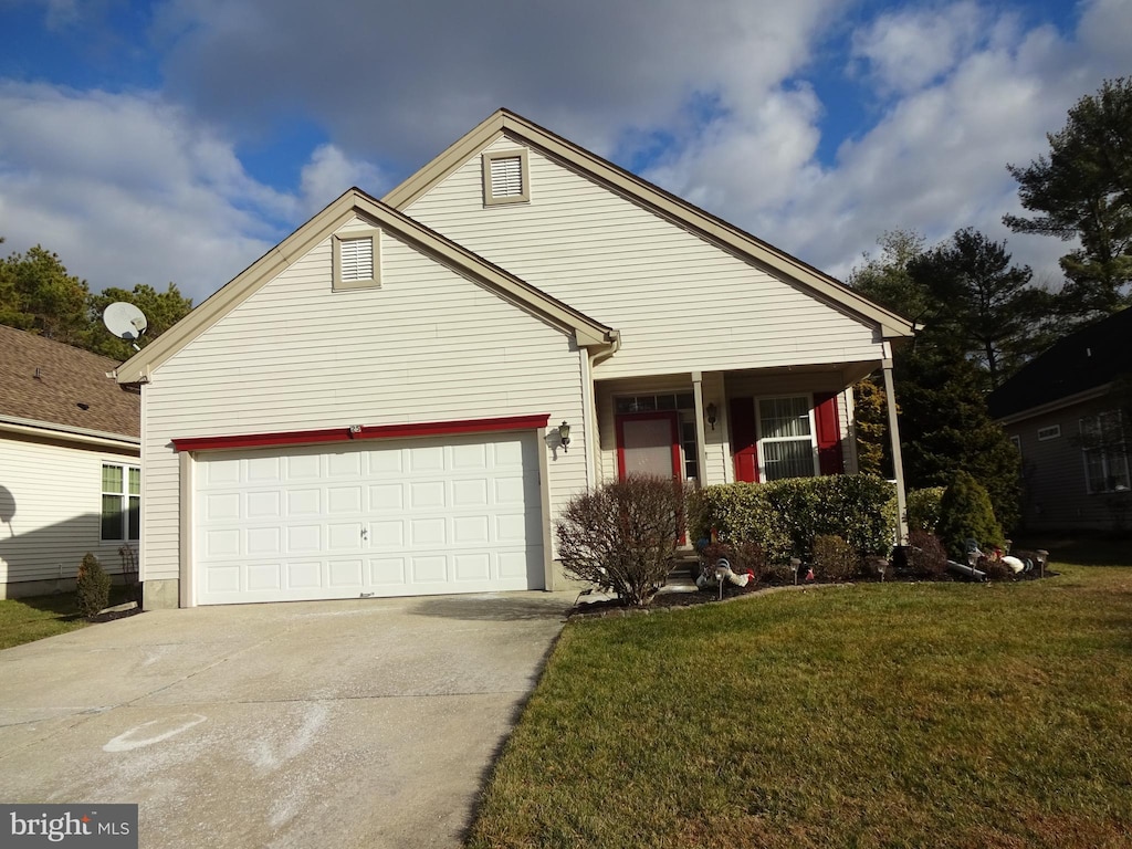 view of front of property with a front lawn and a garage