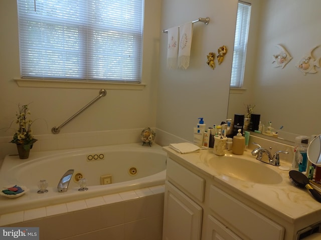 bathroom featuring vanity and a relaxing tiled tub