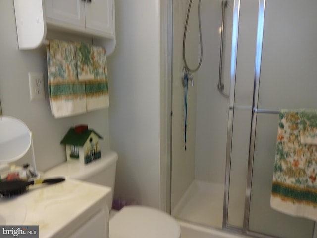 bathroom with vanity, toilet, and an enclosed shower