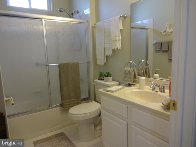 full bathroom featuring tile patterned flooring, vanity, toilet, and shower / bath combination with glass door