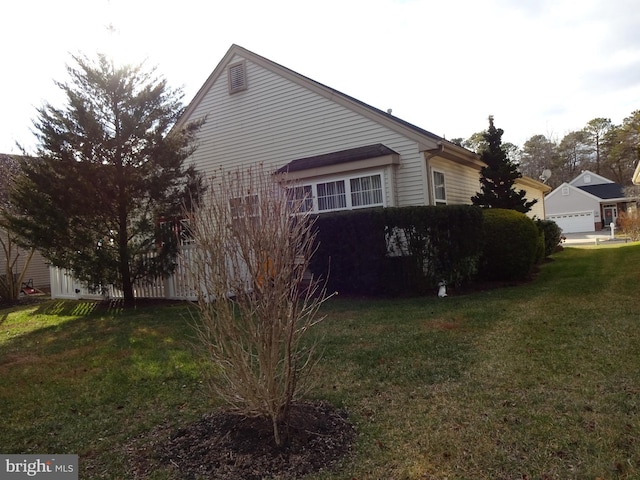 view of home's exterior with a lawn