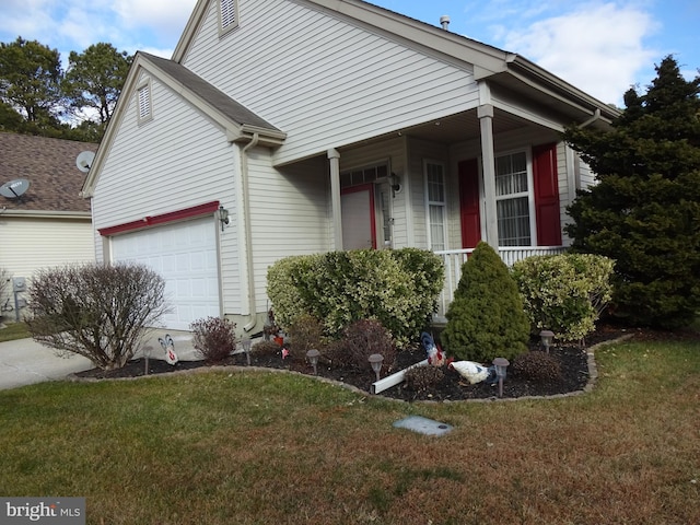 view of front of house with a garage and a front lawn