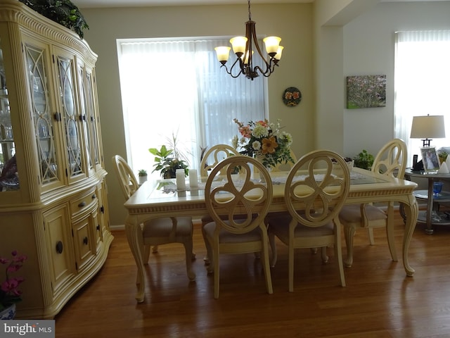 dining room with a notable chandelier and dark hardwood / wood-style floors